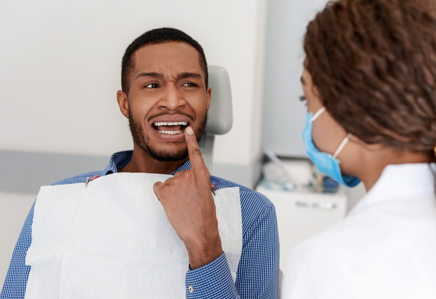 Black Guy Visiting Dentist, Showing Doctor Painful Teeth
